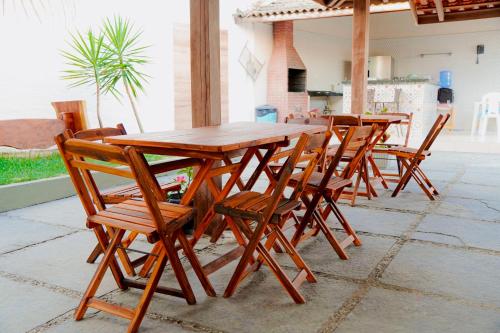 a wooden table and chairs on a patio at Residência Lençóis Pousada in Barreirinhas