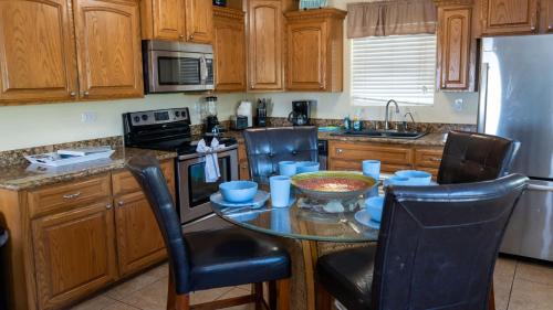 a kitchen with a small table with chairs and a sink at Four Bedroom Two Level Home Near Beach in South Padre Island