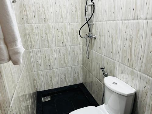 a bathroom with a toilet and a shower at The Liptan Inn in Bandarawela