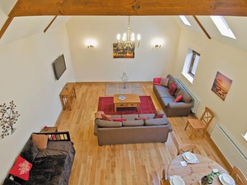 an overhead view of a living room with a couch and a table at Dairy Cottage - E5279 in Durham
