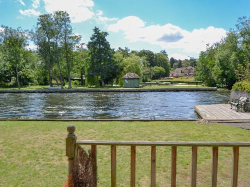 a view of a river from a fence at Watersedge - E1106 in Horning