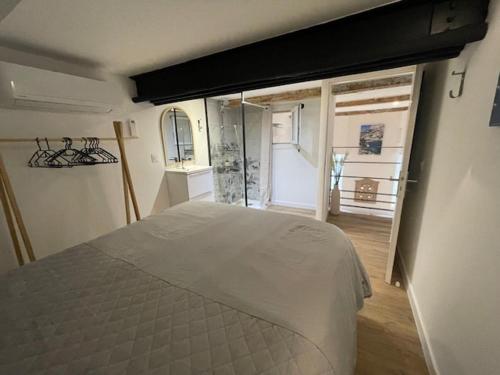 a bedroom with a bed and a large window at Atelier Marius ROCHE in Marseille