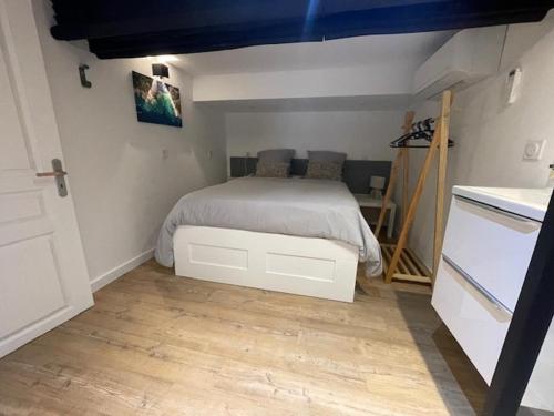 a bedroom with a bed in the corner of a room at Atelier Marius ROCHE in Marseille