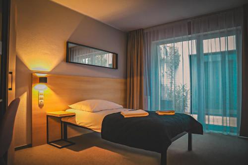 Postel nebo postele na pokoji v ubytování Hotel Bastio