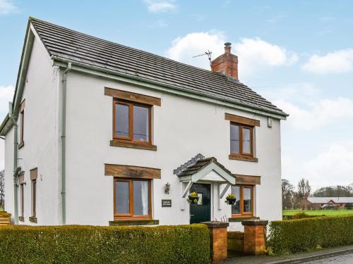 a white house with a black roof at Hornby Cottage in Saint Michaels on Wyre