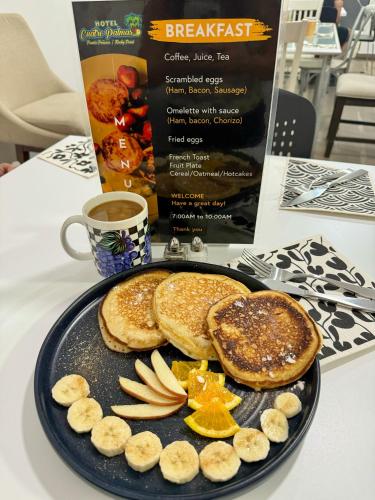 een bord pannenkoeken met fruit en een kop koffie bij Hotel Cuatro Palmas in Puerto Peñasco