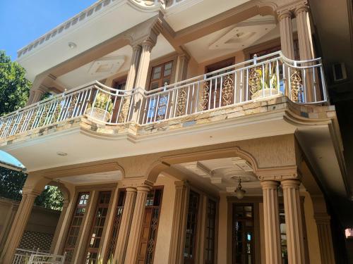 a large house with a balcony on top of it at Cape Villa in Arusha