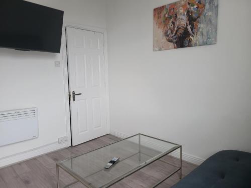 a living room with a glass coffee table and a painting at Quiet 1Br Retreat- Fast Internet- Walk-In Shower in Cork