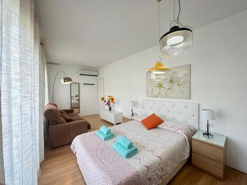 a bedroom with a bed with two pillows on it at Rooms Borrells in Barcelona