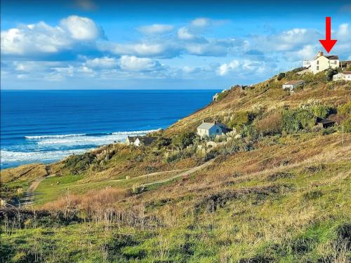 a house on a hill next to the ocean at Bishop Rock - Grl in Trevilley