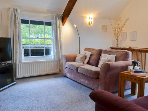 a living room with a couch and a television at Myrtle Loft in Instow