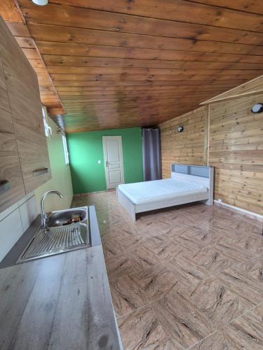 a room with a bed and a sink in it at Chalet Les Planifolias in Saint-Philippe