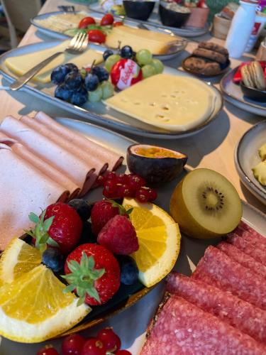 a table with fruits and other food on it at B&B De Zandput in Balen