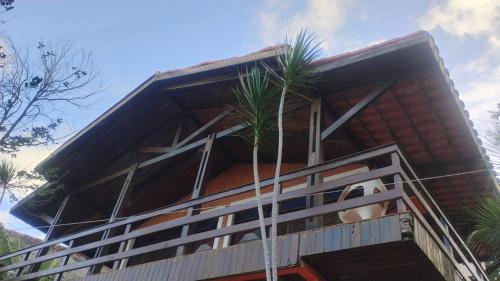 a building with palm trees in front of it at Pousada Solar de Maria e Hostel in Baixa de São Francisco