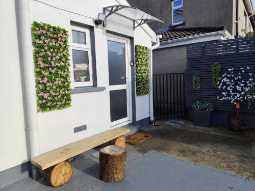 a house with a bench in front of a window at Amy's Suite in Killarney