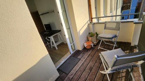 a balcony with chairs and a table and a desk at Ruhiger Flussblick vom Balkon in Niederdorla