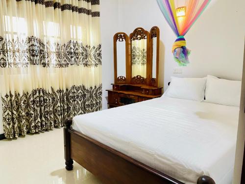 Ένα ή περισσότερα κρεβάτια σε δωμάτιο στο GoCeylonHomestay