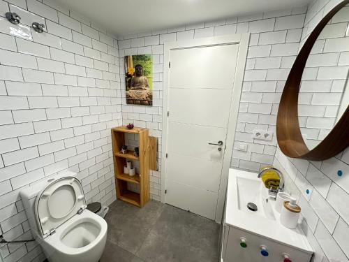 a bathroom with a toilet and a sink at Rooms Borrells in Barcelona