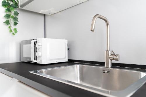 a kitchen counter with a sink and a toaster at Baroni C - FREE private parking-wi- fi and A-C in Gerenzano