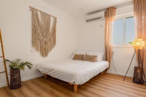 a white bedroom with a bed and a window at Perfect Family Vacation-Private Pool Eilat in Eilat