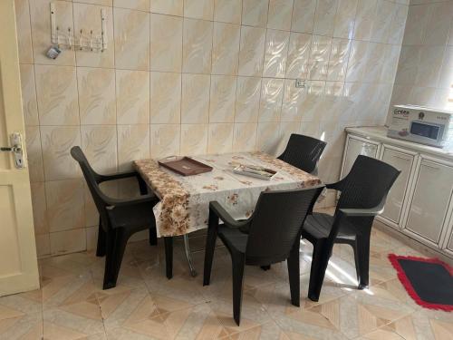 a dining room table with chairs and a tableasteryasteryasteryasteryasteryasteryastery at 2 Bedroom apartment in Jerash Centre in Jerash