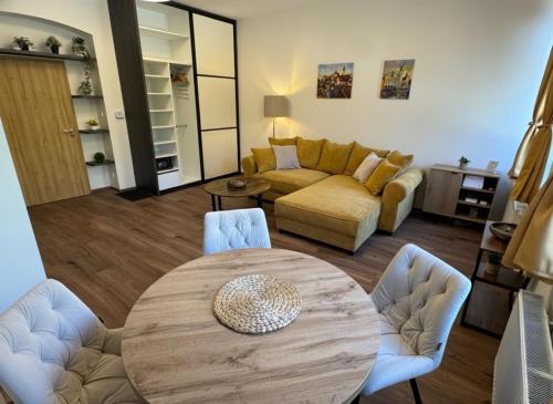 a living room with a table and a couch at Samaya Apartment in Litoměřice