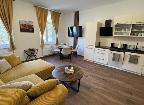 a living room with a couch and a table at Samaya Apartment in Litoměřice