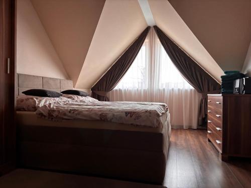 een slaapkamer met een bed en een groot raam bij Apartment Horec Donovaly in Donovaly