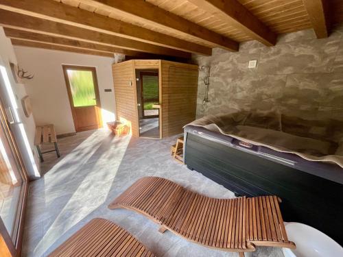 een slaapkamer met een bed en een stenen muur bij Farma Javor in Horná Lehota