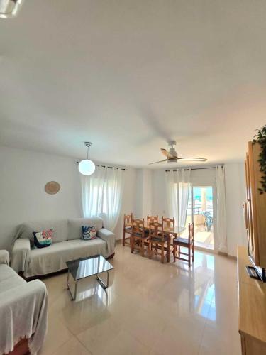 a living room with a couch and a table at Brisa MarinaTerraza Vistas a la Isla Free Parking in Carboneras