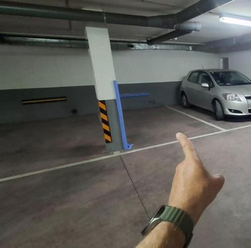 a hand pointing at a parking garage with a car at Brisa MarinaTerraza Vistas a la Isla Free Parking in Carboneras