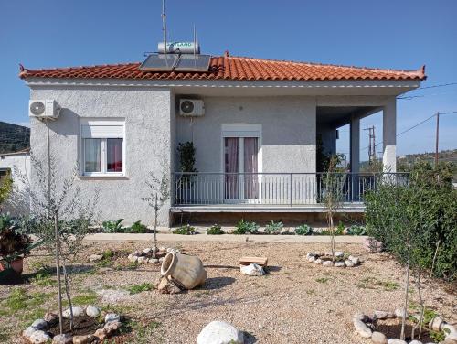a house with a yard with trees in front of it at Classic Guesthouse Nafplion in Nafplio