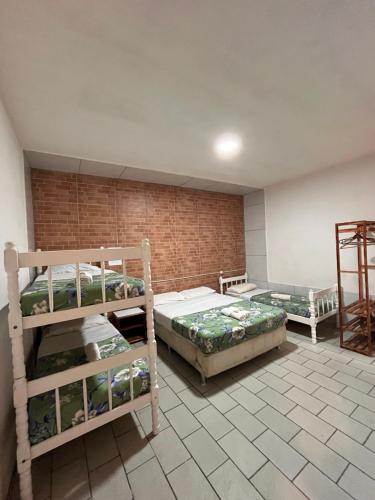 Ένα ή περισσότερα κρεβάτια σε δωμάτιο στο BC Paradise Hostel & Suítes