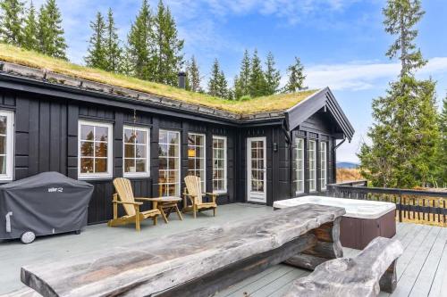 a black tiny house with a grass roof at Fagerasen 303 by Vacation Trysil in Trysil