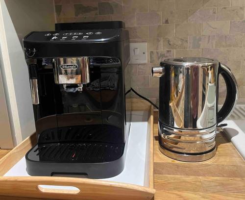 a black coffee maker sitting on top of a counter at Rosemarinus a Peaceful 4Bed 3Bath Townhouse Ballycastle in Ballycastle