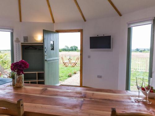 a dining room with a table and a view of a field at Bay in Wootton Bridge