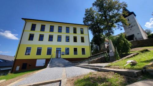 a yellow building with stairs leading to it at Šumavská pohoda Zdíkovec 21 in Zdíkov