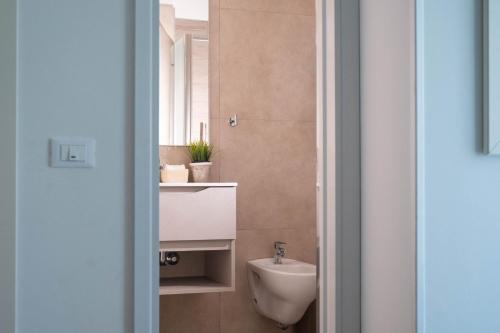 a bathroom with a toilet and a sink at Hotel Philadelphia in Cattolica
