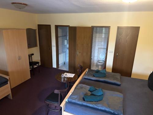a living room with two beds and a table at Motel Zur Festwiese in Gierstädt