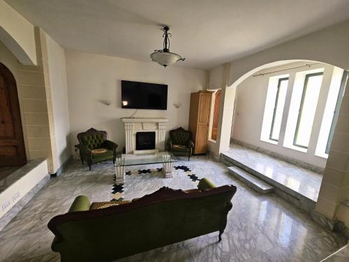 a living room with a couch and a fireplace at Spacious Swieqi Villa for Families Groups Close to Paceville and St Julians in Is-Swieqi