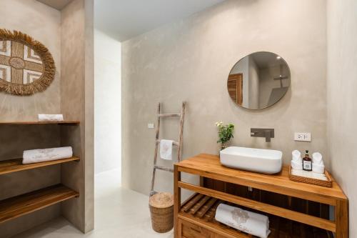 a bathroom with a sink and a mirror at Stunning Koh Samui Villa with Infinity Pool & Ocean View "Villa Sabaï Dii" in Koh Samui