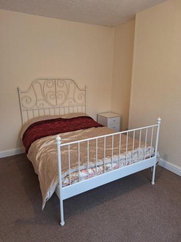 a bedroom with a white bed in a room at Pearl Beach House, Lincs in Mablethorpe