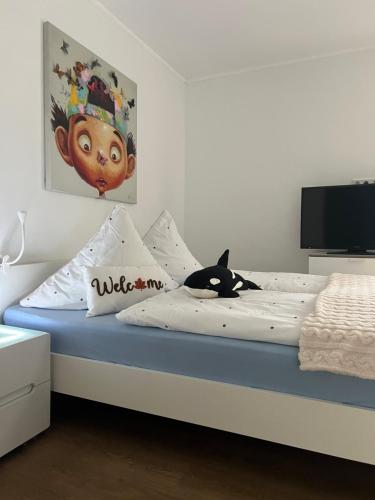 a bedroom with a bed with a black cat laying on it at Appartement am Teich in Krefeld