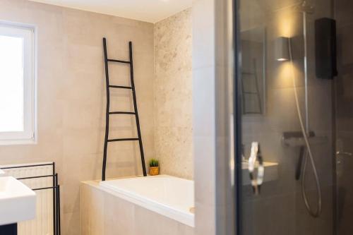 a bathroom with a shower with a ladder on the wall at Prestige 70m2 Two-Bedroom Apartment - VW142A in Eindhoven