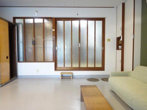 a living room with a couch and a table at 豊橋南栄駅徒歩1分 最大9名一棟貸 ホタルヤ Guest House Hotaruya Toyohashi Minami Sakae in Toyohashi