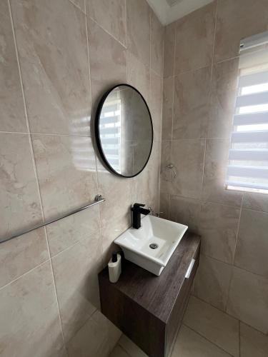 a bathroom with a sink and a mirror at Waterfall Deluxe ll in Rustenburg