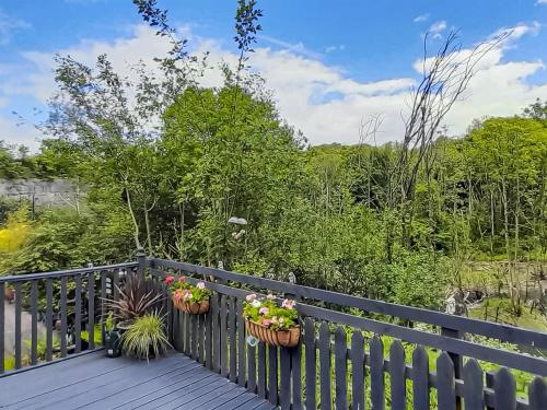 a balcony with two potted plants on a fence at Graylings Rest - Uk35759 in Brigham