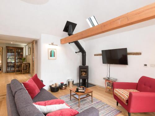a living room with a couch and a fire place at The Old Surgery in Charlton