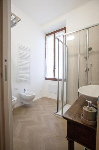 a white bathroom with two sinks and a shower at Stella Maris B&B in Brescia