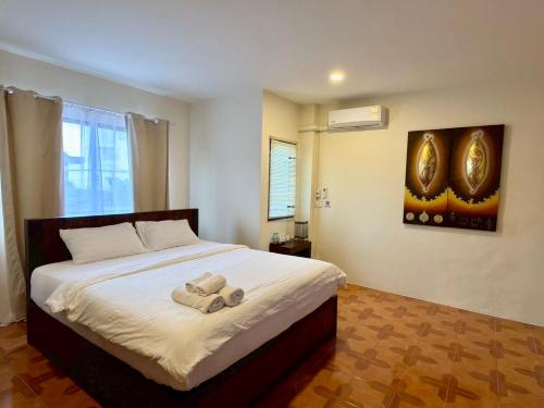 a bedroom with a bed with two teddy bears on it at inghome & guesthouse in Chiang Mai